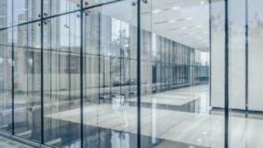 commercial-building-corridor-seen-through-glass-walls-GettyImages-1133174991-1300w-867h