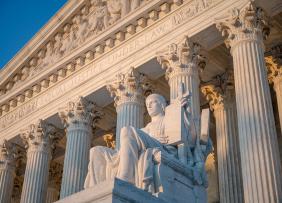 us-supreme-court-statue-and-pillars-GettyImages-1167833543-1300w-867h