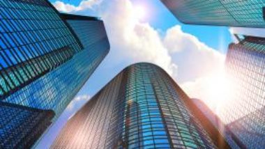 looking-up-at-tall-office-buildings-and-blue-sky-GettyImages-901001432-1300w-867h