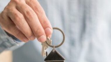 hand-holding-house-key-chain-gettyimages-978724382-03-16-2023-1300w-867h