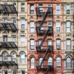 brick-apartment-buildings-with-fire-escapes-gettyimages-1407941245-1300w-867h