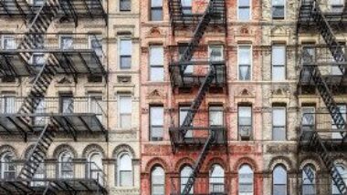 brick-apartment-buildings-with-fire-escapes-gettyimages-1407941245-1300w-867h