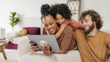 family-in-living-room-looking-at-a-tablet-gettyimages-1345741865-1300w-867h